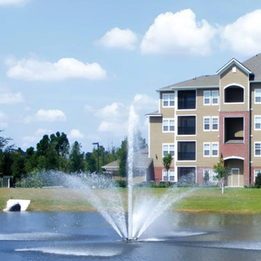 Vertex FanJet Floating Pond Fountain With Colorful Huge Building Behind